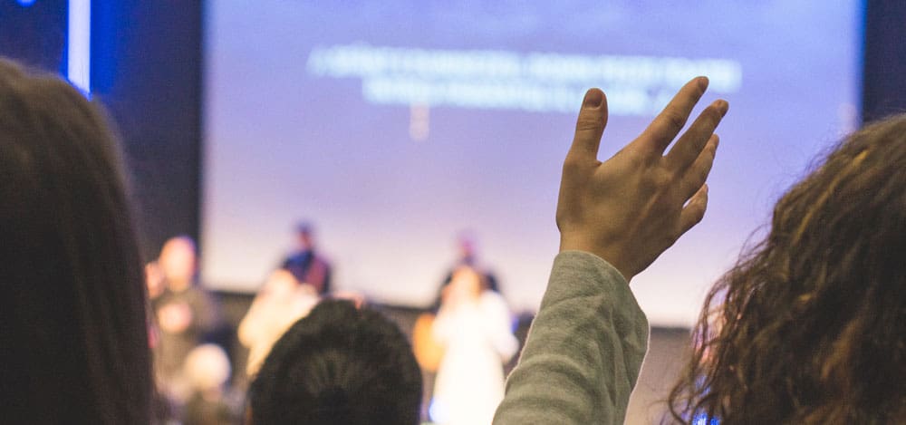 church goers participating in worship singing