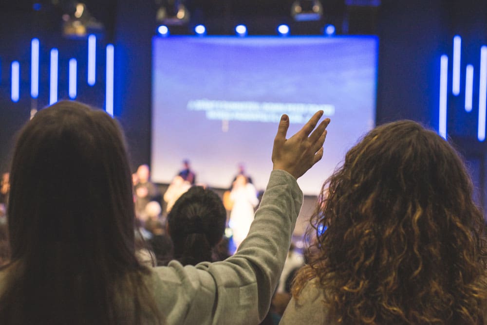 church goers participating in worship singing