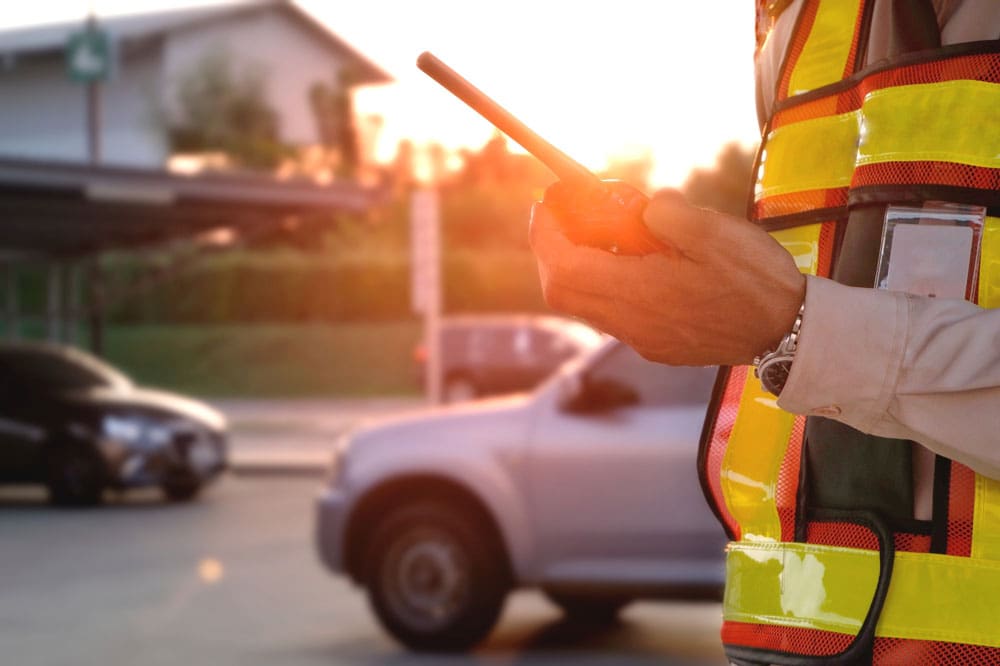 Security guard on his radio in the parking lot of a church